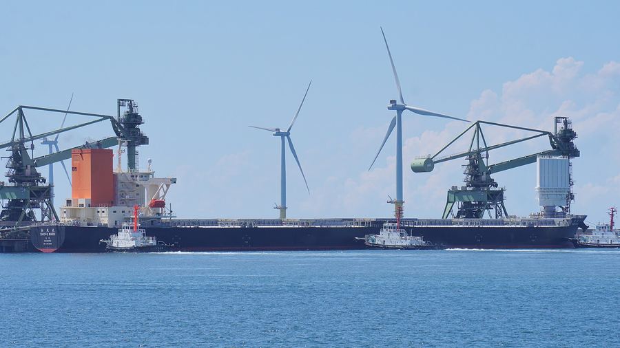 Archive: MOL coal carrier Shofu Maru with bow-mounted Wind Challenger FRP hard sail at Noshiro, Japan, 26 Aug 2023 (掬茶, CC BY-SA 4.0). Not FUJIN SAILOR, not Hanwha Ocean Geoje yard naming 10 Sep 2026, not a Chevron-charter LNG carrier, and not a two-sail LNG installation.