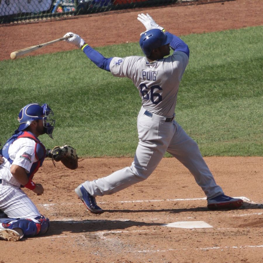 Archive: Yasiel Puig mid-swing follow-through, Dodgers grey road kit vs Cubs at Wrigley Field, 19 Sep 2014 (TonyTheTiger / Wikimedia Commons, CC BY-SA 4.0). Not the 17 September 2026 NL West clinch in Cincinnati, not a Kyle Tucker Dodgers-kit still, and not a Great American Ball Park day-of still.