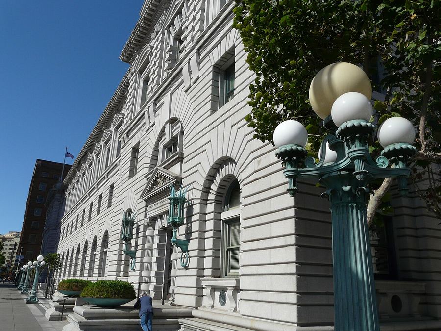 Archive: James R. Browning U.S. Courthouse, the historic Post Office and Court House, San Francisco — grey stone facade and globe lampposts. Blackhorsemedia, License CC BY-SA 3.0. Not the 25 September 2026 settlement announcement, not day-of union or White House budget office photography, and not a press-conference still.