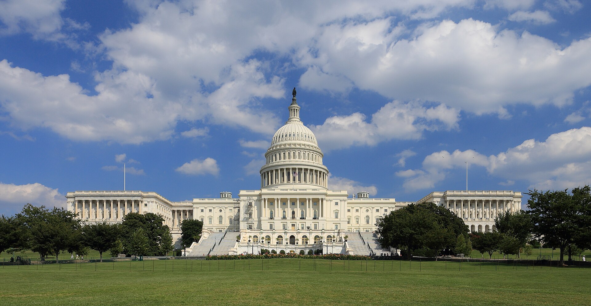 Archive: West front of the United States Capitol, Washington, D.C. — the full dome with the Statue of Freedom, both wings and the west lawn under a clouded blue sky. Martin Falbisoner, License CC BY-SA 3.0. Not the 25 September 2026 request to cancel $810 million, not day-of White House or congressional photography, and not a signing still.