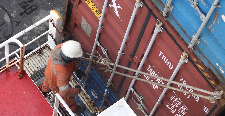 Archive photo: a crew member secures stacked containers with steel lashing rods aboard the cargo ship Pollux in Tórshavn, Faroe Islands, the hand work the new design is meant to replace, in September 2018.